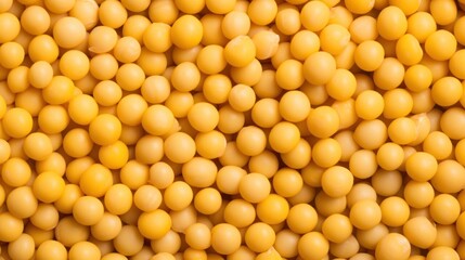  a close up of a bunch of small yellow balls on a white surface with a black border around the top of the image.