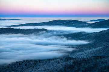 Beautiful winter mountain landscape. Moody sunset seen from the Mount Smerek in the Bieszczady National Park, Poland.