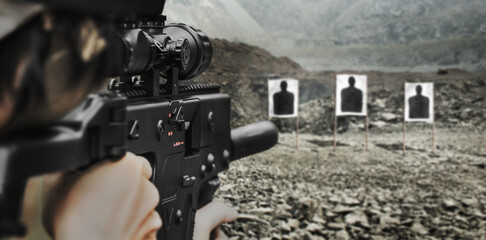 Military soldier shooter aiming sub machine assault rifle weapon at outdoor academy shooting range