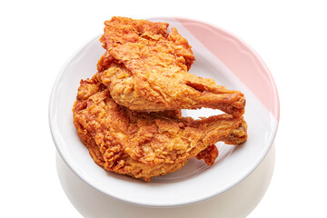2 large chicken thighs batter and deep fried in plate isolated on white background. fried chicken is a dish consisting of chicken pieces that have been coated with seasoned flour or batter.