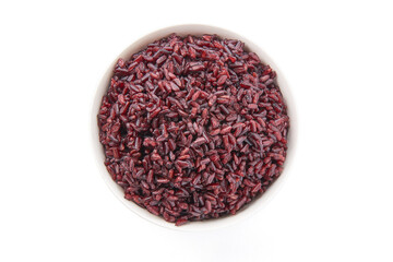 Top view of cooked riceberry in a white bowl isolated on white background. Riceberry rice is dark purple rice similar to ripe berries, rich in nutrients and has good anti-oxidant properties.
