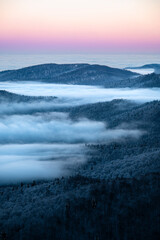 Beautiful winter mountain landscape. Moody sunset seen from the Mount Smerek in the Bieszczady National Park, Poland.