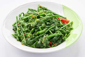 Chayote leaves ( young leaves) with oyster sauce in plate isolated on white background.