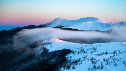 Beautiful winter mountain landscape. Moody sunset seen from the Mount Smerek in the Bieszczady National Park, Poland.