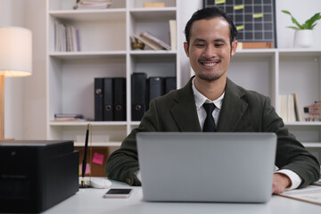 Happy smile professional business man online working, focused ethnic male student working on laptop, remote studying using computer laptop looking at screen watching seminar webinar at home office.