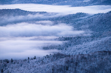 Beautiful winter mountain landscape. Moody sunset seen from the Mount Smerek in the Bieszczady National Park, Poland.