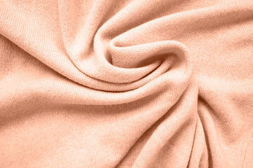 Cashmere scarf texture. Top view, close-up. Peach fuzz is color of year 2024.