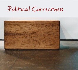 Card holder with paper written Political Correctness on copy space desk- means avoiding language...