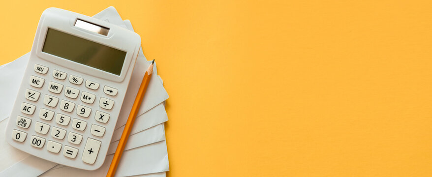 close up top view on calculator and invoice mail from bank on yellow background for money and debt management concept