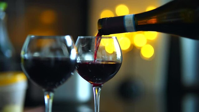 Red wine poured into wine glass in restaurant