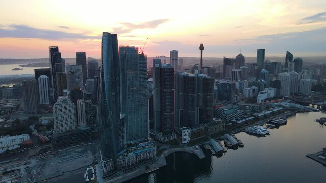 Aerial drone rotation view of Barangaroo waterfront precinct in Sydney City, NSW Australia during a morning sunrise in December 2023