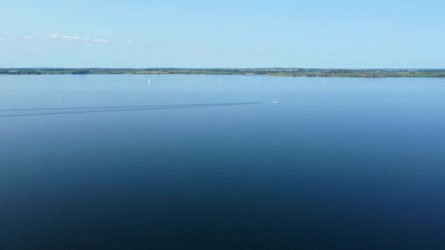 Aerial drone footage small motorboat driving on the Baltic Sea in Northern Germany