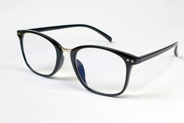 Reading glasses with black frames and a white background