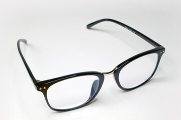 Reading glasses with black frames and a white background