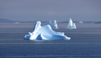  icebergs and  distant islands,  near nanortalik near tasermiut fjord  in southern greenland, on a  cruise ship in summer © Nina