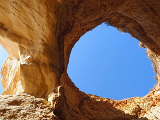 View of the sky through a opening in a Algarve cave in Portimao Portugal