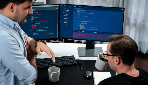 IT developers discussing online software development information on pc screen, creating program coding for latest version application on website. Concept of brainstorming firmware updated. Sellable.