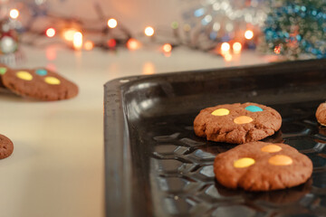 Homemade cookies on a baking sheet. Beautiful New Year's background. Baking with colored candies....