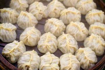 Steamed mantas are cooked in a wooden steamer in close-up. Background. Selective focus