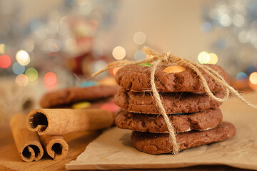 Cookies folded in a column and tied with cinnamon-flavored rope. Creative presentation in the store. Sweet pastries with candies for children. New Year background.
