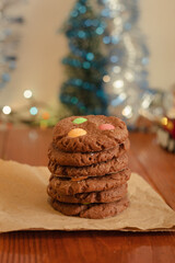 Shortbread brown cookies folded in a column on parchment paper. Sweet pastries for the New Year holidays. Blurred bokeh background. Front view close up.