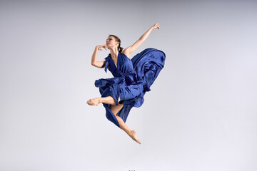 girl in Waving Fabric performing at studio creative choreography female fit girl practising...