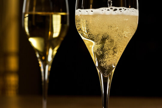 Sparkling champagne in a glass in a dark festive room