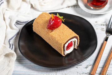 Roll cake. Strawberry roll cake with delicious cream on a white background