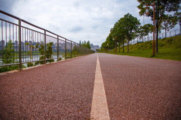 promenade, cycling and jogging path overlooking the city. City, trees, lantern,