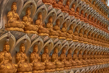wall of miniature buddha statues diagonal 
