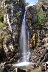 Obraz premium Beautiful waterfall on a mountain, with a small lagoon below, Gerês, Portugal