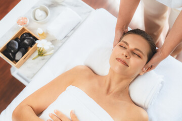 Obraz na płótnie Canvas Panorama top view of woman enjoying relaxing anti-stress head massage and pampering facial beauty skin recreation leisure in dayspa modern light ambient at luxury resort or hotel spa salon. Quiescent