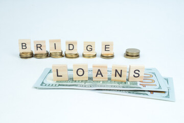 Bridge loans- word composed fromwooden blocks letters on White background, copy space for ad text. - obrazy, fototapety, plakaty