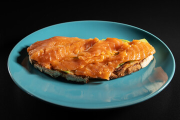 avocado toast with salmon on rye bread toast, fresh breakfast, healthy eating