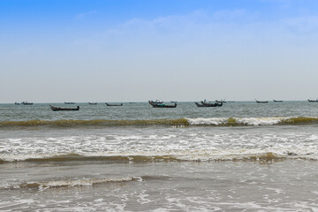 Boats on the sea beach with waves coming