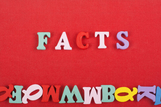 FACTS word on red background composed from colorful abc alphabet block wooden letters, copy space for ad text. Learning english concept.