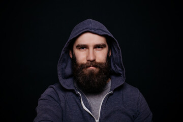 Handsome male beard in hoodies, studio shot black background
