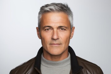 Portrait of handsome mature man with grey hair in leather jacket.