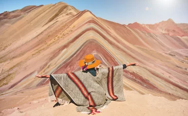 Papier Peint photo autocollant Vinicunca Panoramic view, Young girl sitting in front of the Vinicunca Rainbow Mountain, Peru South America