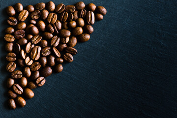 coffee beans on a black board background, copy space