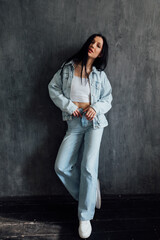 fashionable brunette woman in summer denim suit