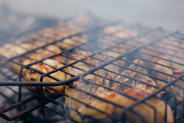 Grilled chicken Leg on the grill, over coals with smoke