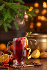 Christmas mulled wine with spices, citrus, and vintage kitchen utensils.