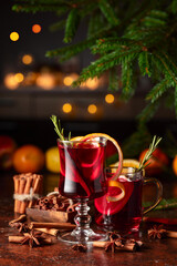 Christmas mulled wine with citrus, apples, cinnamon, anise, and rosemary.