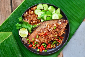 fried fish,Garlic fried fish,pikled fish, top view food table, With side vegetables  dishes, thai...