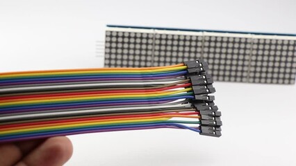 Jumper wires of different colors with LED dot matrix display module on the background