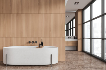 White and wooden bathroom interior with tub and sink