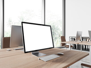 Coworking interior with pc computer on table with mockup display, window