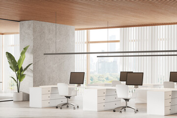 Stylish office workspace interior with pc computers on desk, panoramic window
