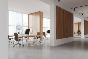 Stylish workspace interior with desk and pc monitors, panoramic window